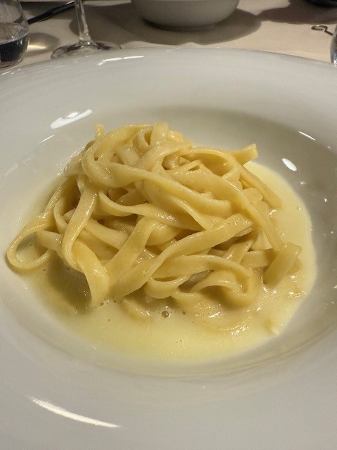 Plate of fettuccine pasta served with a creamy sauce.